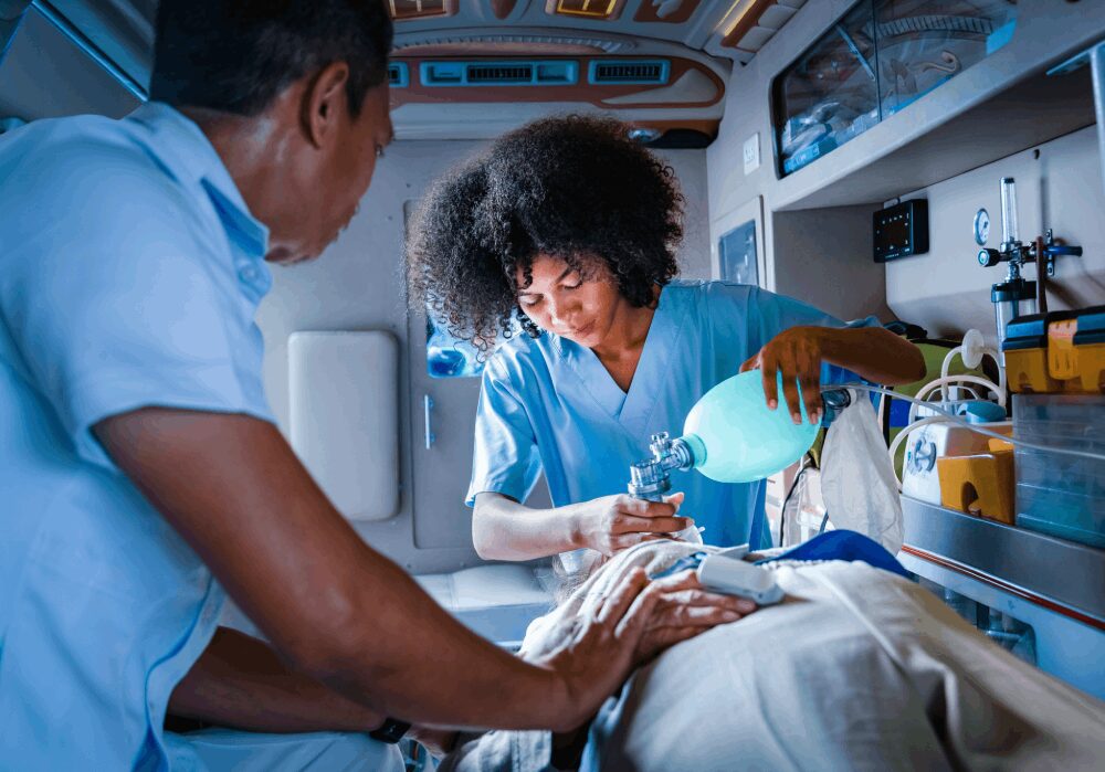 Paramedics assisting patient inside an ambulance.