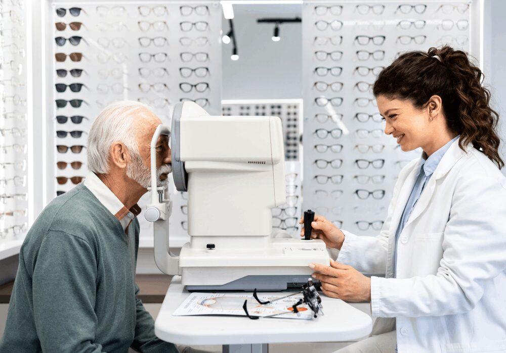 Optometrist examining an elderly man's eyes.